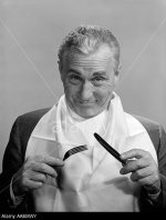 1950s-1960s-elderly-man-wear-napkin-as-bib-smiling-holding-knife-fork-AAMXWY.jpg