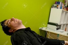 6880872-Young-man-in-black-shirt-sleeping-in-chair-Stock-Photo.jpg