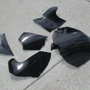 F1 shield... broken with one brick from eye level.  Do you really want to ride behind this?  Do you want knife-sharp pieces flying at you?