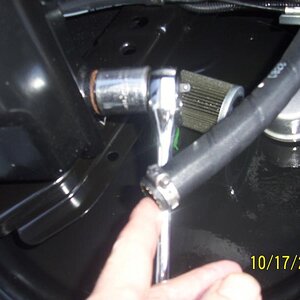 simple worm clamp works just fine and removable for the next oil change.