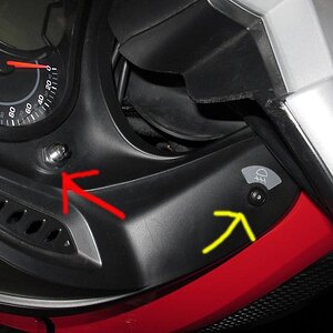 This is a shot of the switch our dealer put on for my garage door remote. The red arrow points to the new switch (chrome) - the yellow arrow points to