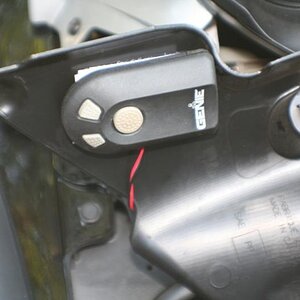 Garage Door opener mounted under computer and fuse cover.