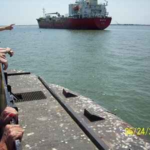 On the ferry between Galveston and Bolivar Peninsula.  The two black dots near the ship are porpoises.