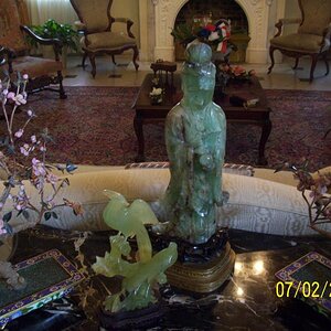 Oldest piece in the house. Skinny Buddha. Translucent. The pink trees are made with Jade petals as is the Buddha and the other figurine.