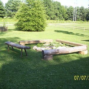 Benches around a fire pit; for sitting a spell and talking perhaps.