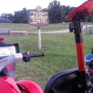 Teddy ryde'n redneck style with a stripped sled at the airport viewing area & marker showing the area was the center of population back in 1880