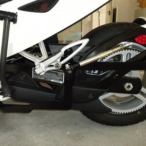 Wheelchair bracket with folding arms, held on by two bolts. One bolt through existing rear foot peg and second through hole drilled into ISCI floorboa