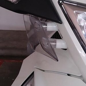 Extension spacer for the air deflector under the mirrors