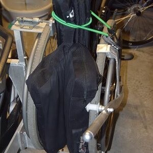 The only thing the bungy does is compress the back of the folded chair to give better visibility to the Spyder driver. It has nothing to do with holdi