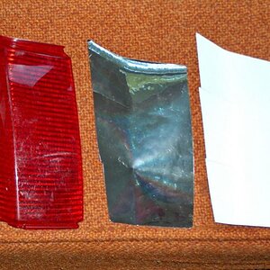 GIVI Bag Lens Backing.  Bare lens on left, new chrome reflective tape  in center, original white backing plastic on right.