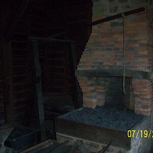 The forge. No coal so they first had to make charcoal...bellows, anvil, all authentic.