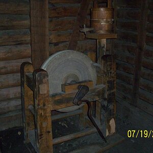 Whetstone or grinding stone. Small barrel of water atop to help cool off while grinding so you don't break the blade.