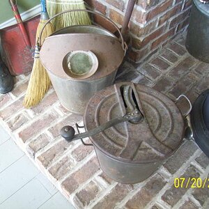 Old time bread machine. Has instructions about adding flour and stuff on the lid. Bucket and wood stove.