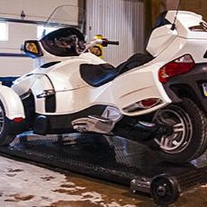 Can-Am Spyder on deck in shop.  Deck is easily removed and easily re-attached with two retaining pins.