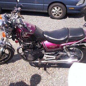 My very first (legal) street bike. This is a 1984 450 Honda Nighthawk. The side of the tank was caved in & it was faded horribly, so, it became this..