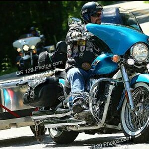 Eaven with trailer, Casey in back. My husband (towing the trailer) which he custom built out of checker plate aluminum & me trailing behind him on my 