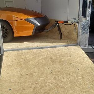 Freedom trailer hitched inside of enclosed trailer