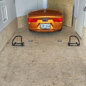 Freedom trailer hitched inside of enclosed trailer and wheel chocks anchored to floor for the Spyder front wheels to rest in when transporting