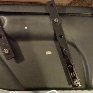 The bolt holding the silver washer is just there to position the bracket. It is removed and replaced with a longer bolt and the bracket and bag are at