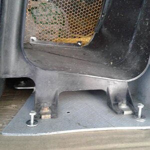 I use large screws two in each air duct opening , to secure it to the plywood platform bolted to the truck box frame .... it touches nothing, and does