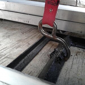 this is the hook end that attaches to the cradle,  bolted to the trk frame ....the strap goes over the top of the tire and the Ratchet end is attached