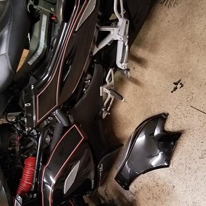 Remove the left center panel, raise the seat and remove the left rear panel and for a best view remove the lower airdam as well...