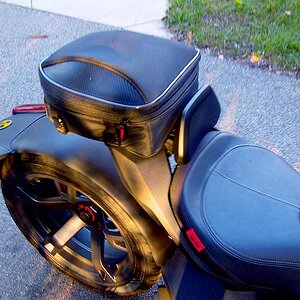 The Nelson Rigg tail bag is handy and fits using the hardware provided using a bit of creativity. Well made and solid strapped to the Max Mount.