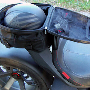 The Nelson Rigg trunk also expands to fit a half helmet and cool weather gear.