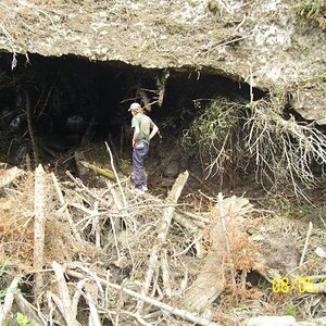 Under the ice; that brownish stuff is snow/ice covered with debris.