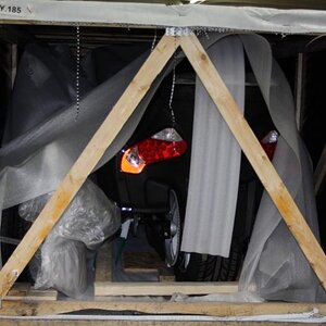 Rear end of crate, tail lights seeing their first view of the U.S.