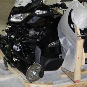 Left front showing frame resting on crate base.