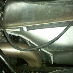 Wiring harness on left side against fuel tank.