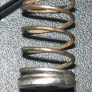 The washer glued to the spring. Take care to clean up any excess glue, or it will bind in the spring well,