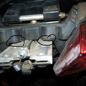 The "circles" show why this mod is worth doing. The two inner screws that mount the taillights are obscured by the plate that supports the sport rack.