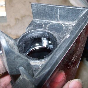 That flange at the top of the pic is in the way. It stops you reaching the bulb holder from below. It has to go...