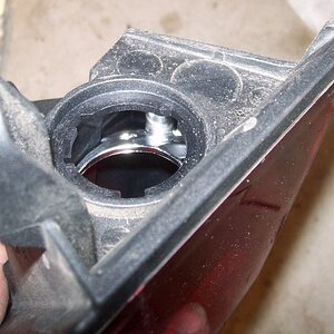 Done. The flange is now gone. It is now possible to remove the globe with the tail light still mounted.