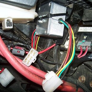 The isolator box mounted to a bracket under the seat. The isolator contains a fet switch and four mosfets to isolate the trailer wiring, particularly 