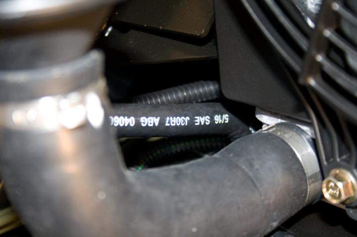 2010 RS SpyderNewEvapCan 4 - The vent hose is seen in the middle of the photo (white writing). At this point, the wire loom ends, as it passes the rad