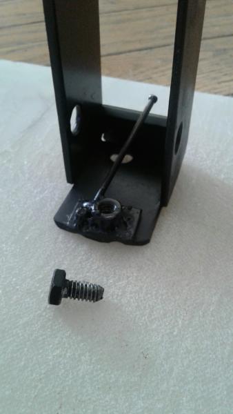 A pic of what the locking plate looks like before it's put into the frame and the bolt used to lock it in place.