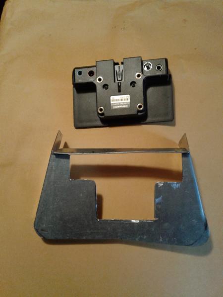 At the top this is the back of the radio connecting device - all the wires go in this ..... The bottom pic is the frame / holder , that the upper piec