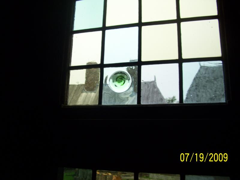 Blown glass from France in the windows. The bubble is the end of the blow. The makers used to leave the nipple on when finished. This would stick out 