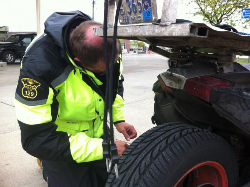 Butch working on Seth's tail lights on the ride home.