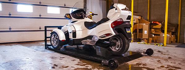 Can-Am Spyder on deck in shop.  Deck is easily removed and easily re-attached with two retaining pins.