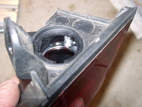 Done. The flange is now gone. It is now possible to remove the globe with the tail light still mounted.