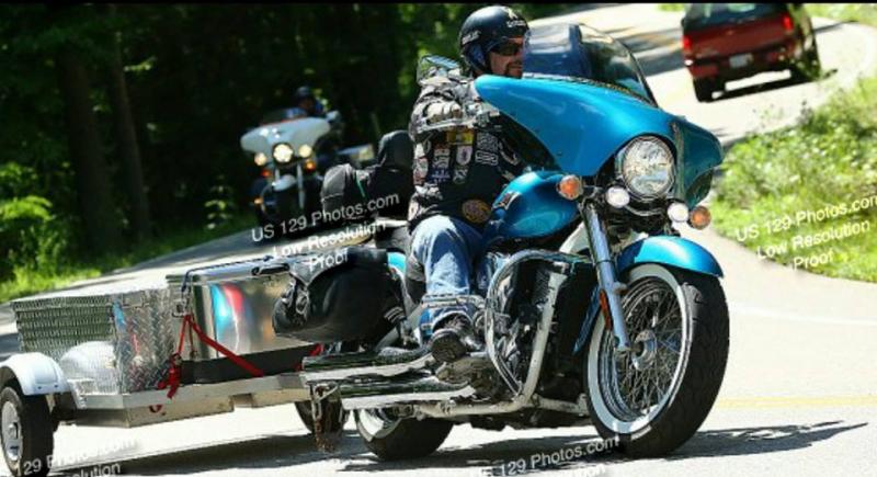 Eaven with trailer, Casey in back. My husband (towing the trailer) which he custom built out of checker plate aluminum & me trailing behind him on my 
