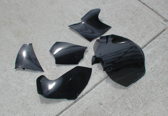 F1 shield... broken with one brick from eye level.  Do you really want to ride behind this?  Do you want knife-sharp pieces flying at you?