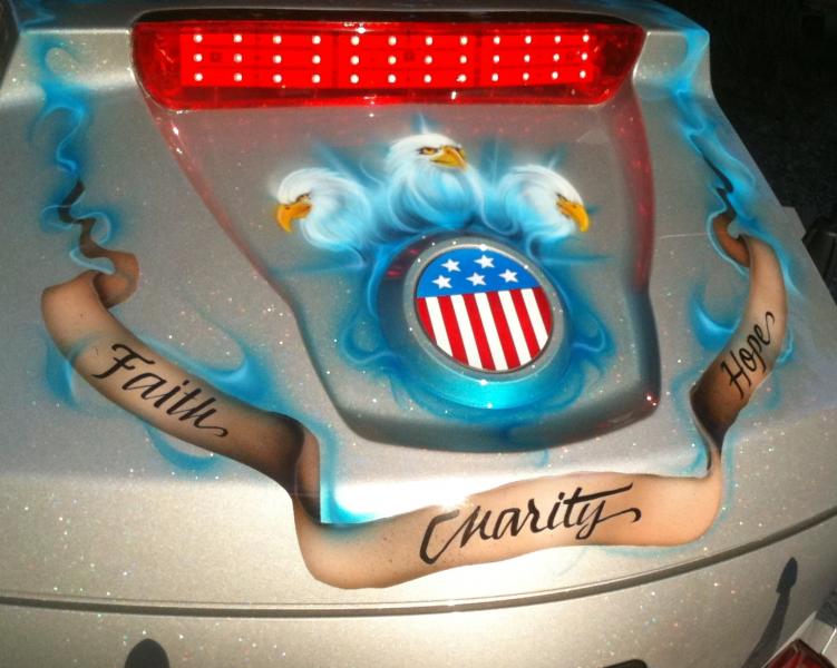 "Faith, Hope, Charity, but the greatest of these is charity"
and the three eagle heads, over the flag emblem,  represents the Trinity.