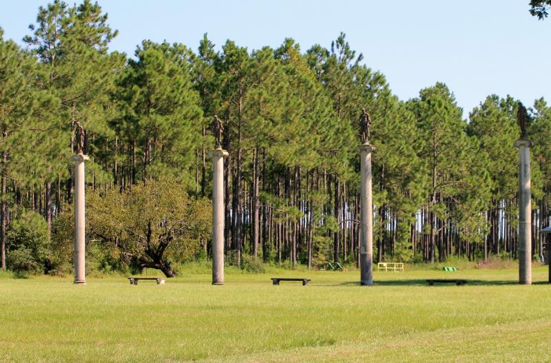 Four thirty foot columns with Greek goddesses