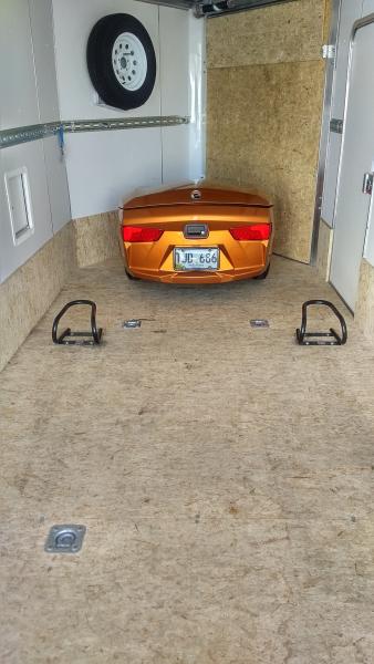 Freedom trailer hitched inside of enclosed trailer and wheel chocks anchored to floor for the Spyder front wheels to rest in when transporting