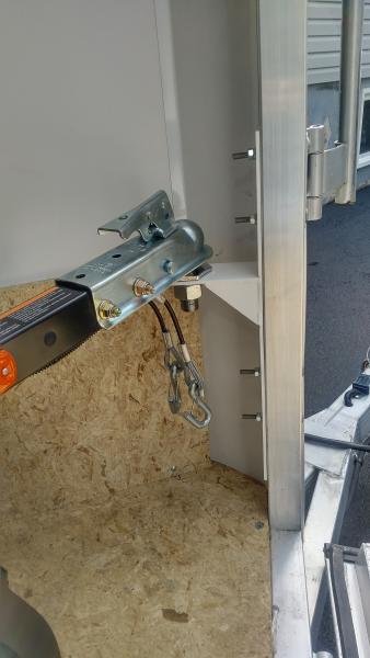 Freedom trailer hitched inside of enclosed trailer